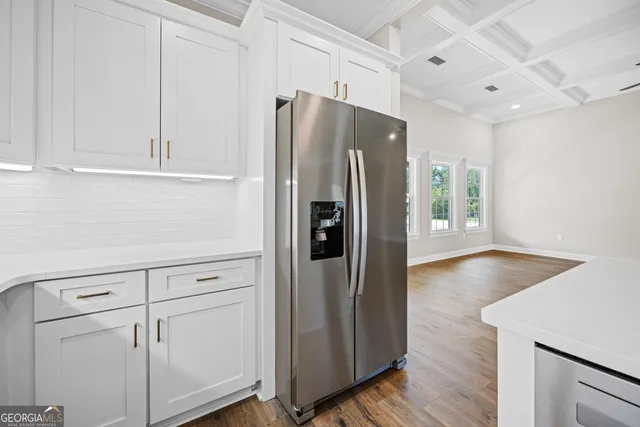 a kitchen with stainless steel appliances a refrigerator and cabinets