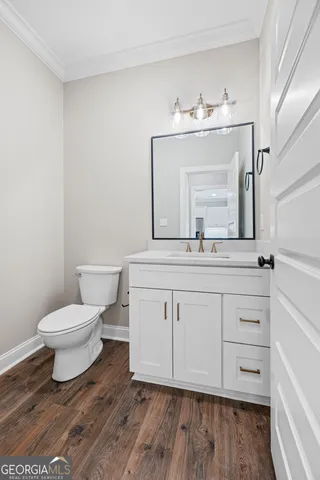 a bathroom with a toilet a sink and a mirror