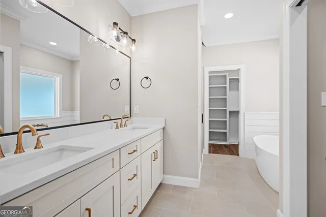 a spacious bathroom with a shower sink and mirror