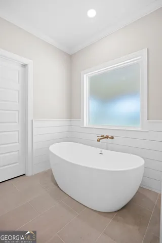 a white bath tub sitting in a bathroom