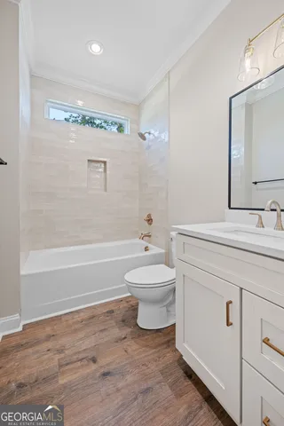 a bathroom with a toilet a sink and a bathtub