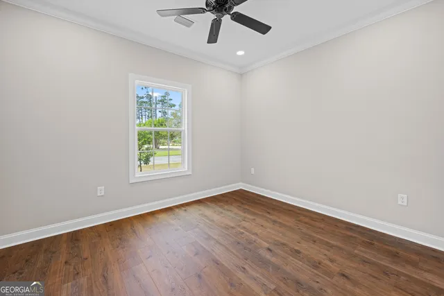 wooden floor in an empty room with a window