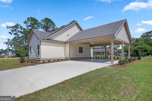 a view of a house with backyard sitting area and garden