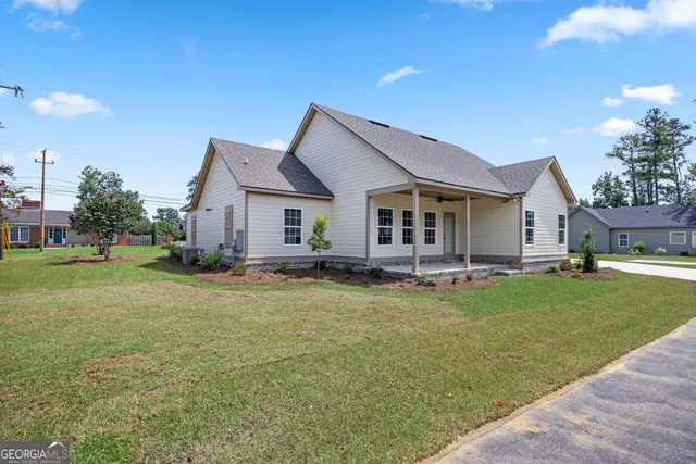 a view of a house with swimming pool and a yard