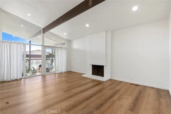 a kitchen with a stove and a wooden floor