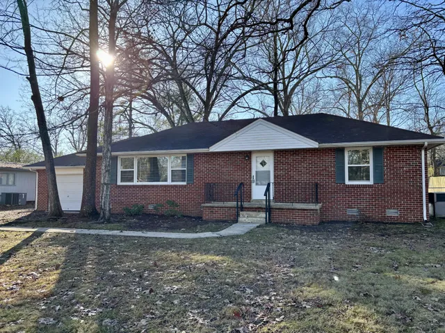 a house that has a tree in front of it