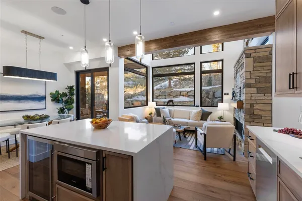 a open kitchen with stainless steel appliances granite countertop a stove and a wooden floors