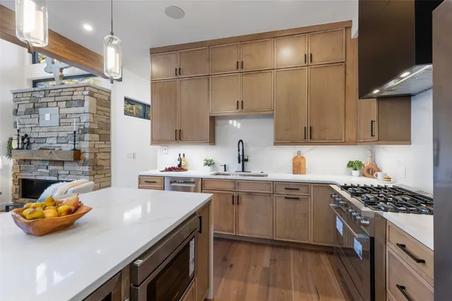 a kitchen with a sink a stove and cabinets