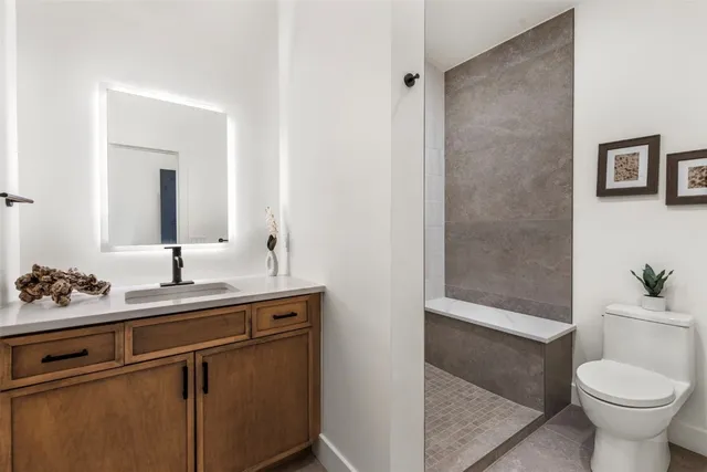 a bathroom with a sink toilet and shower