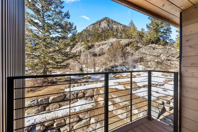 a view of a balcony next to a yard