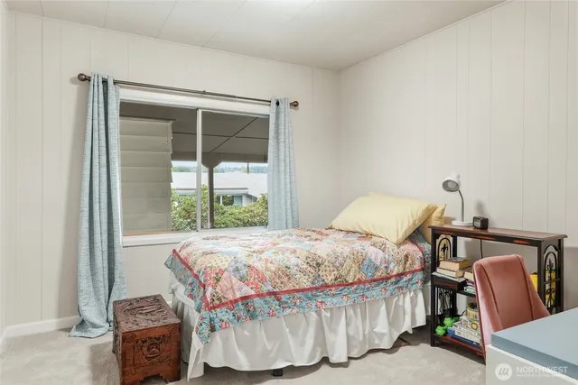 a bedroom with a bed and a chair