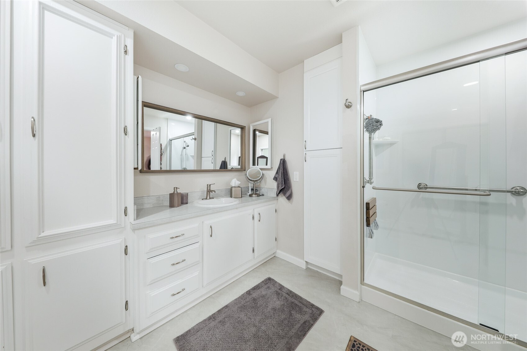 722 Wandering Creek Drive Bothell, WA 98021 - Photo 14 of 23 a bathroom with a sink a mirror and a shower