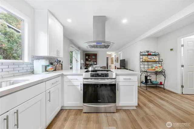 a kitchen with stainless steel appliances granite countertop a stove and a sink