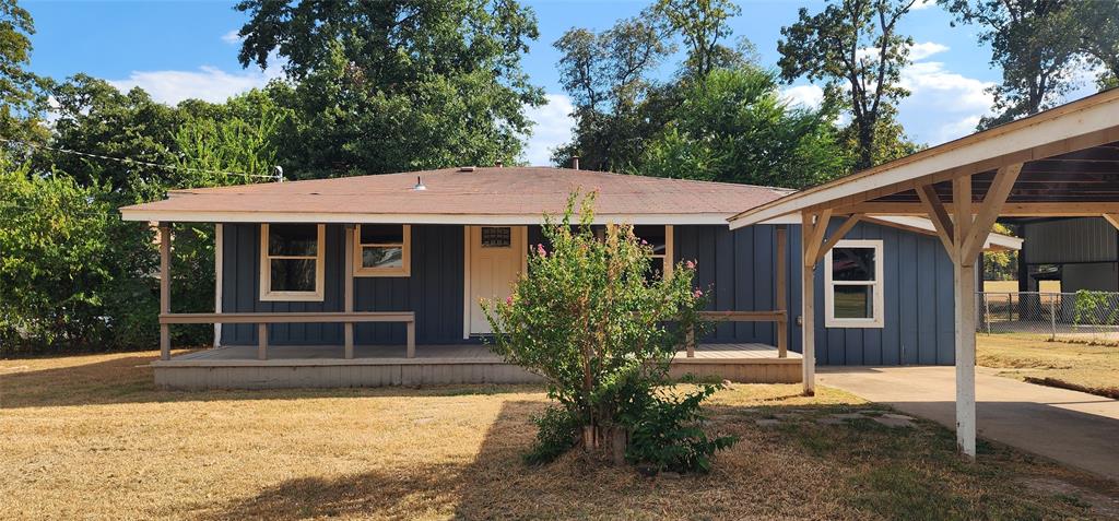 2016 Gavin Road Tool, TX 75143 - Photo 26 of 26 Blue siding exterior with a covered front porch, white-trimmed windows, and an attached carport