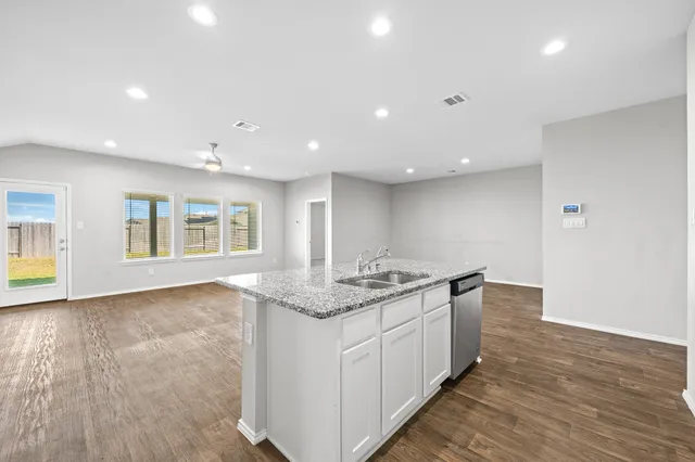 a kitchen with a sink stove and cabinets