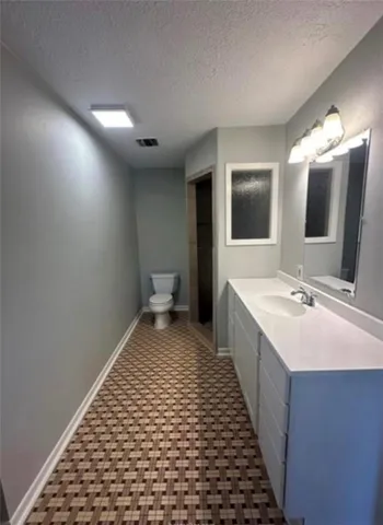 a bathroom with double vanity sink and mirror
