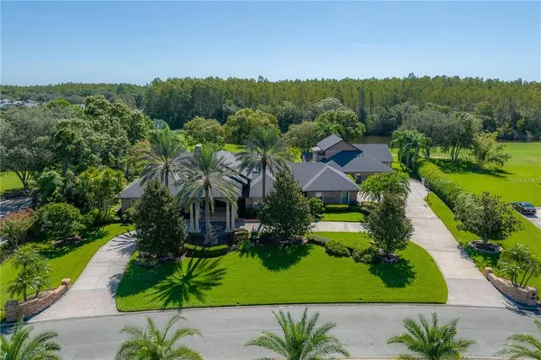 a front view of a house with swimming pool having outdoor seating