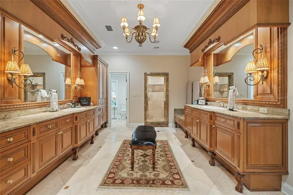 a bathroom with a granite countertop sink a toilet a mirror and shower