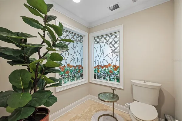 a view of a patio with a table and chairs and floor to ceiling window