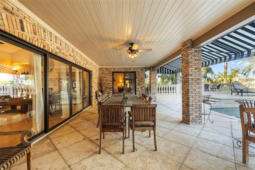 18707 Pepper Pike Lutz, FL 33558 - Photo 42 of 76 a view of a patio with a table and chairs and floor to ceiling window