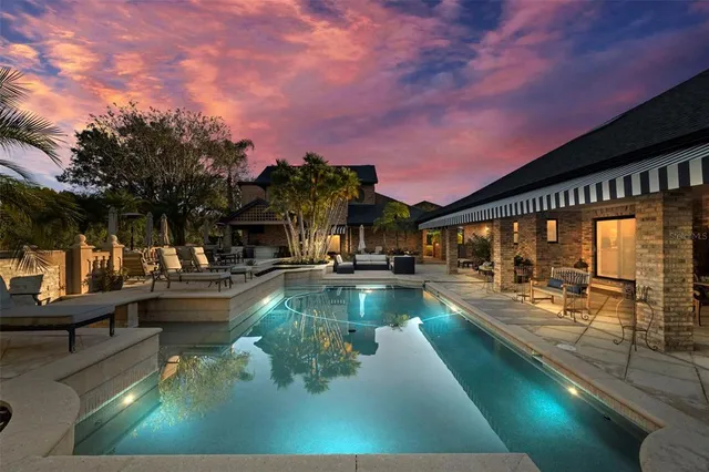 a living room with furniture a clock and a fireplace