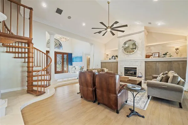 a view of a dining room with furniture a chandelier and wooden floor