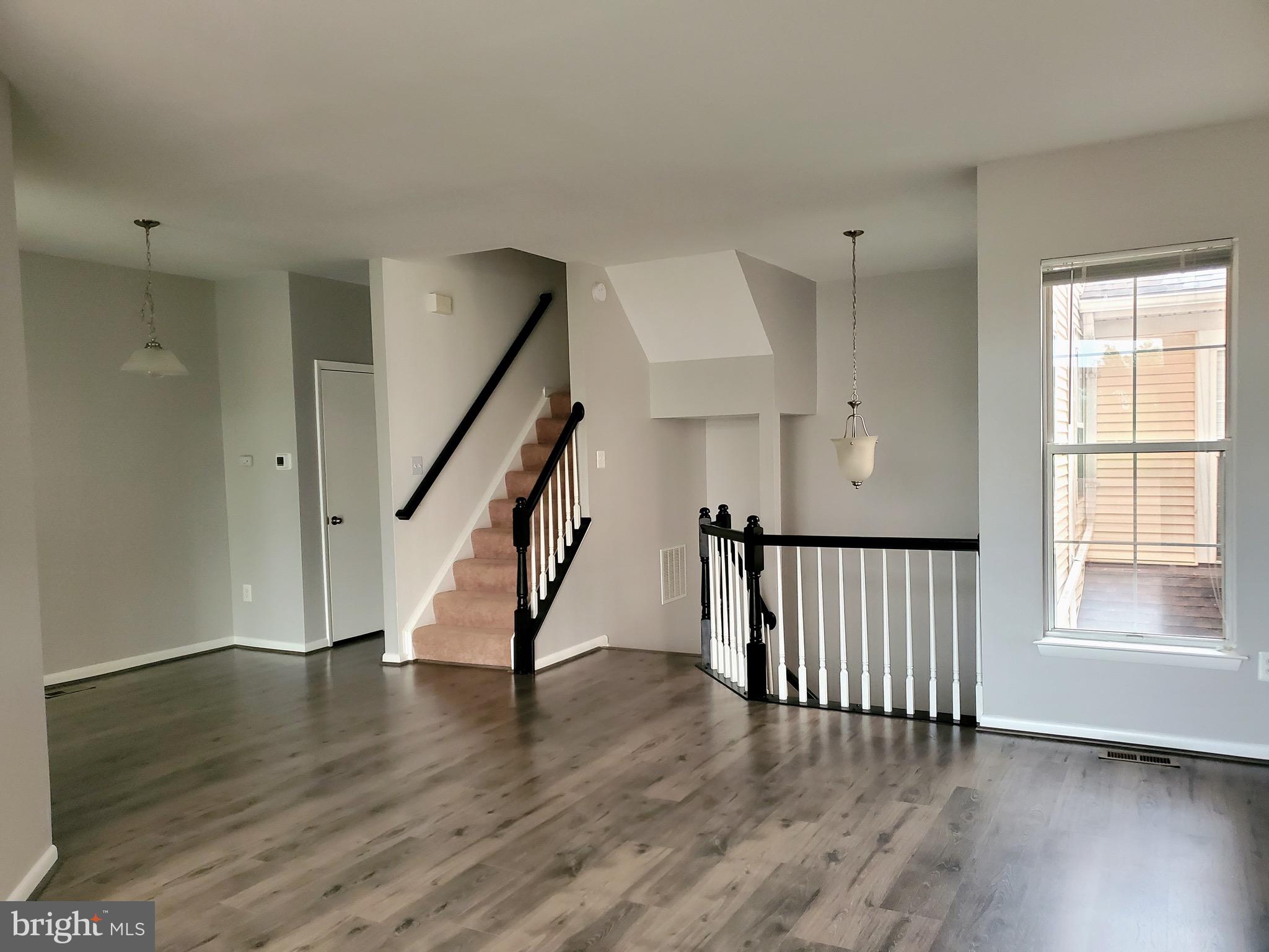 a view of an entryway with wooden floor