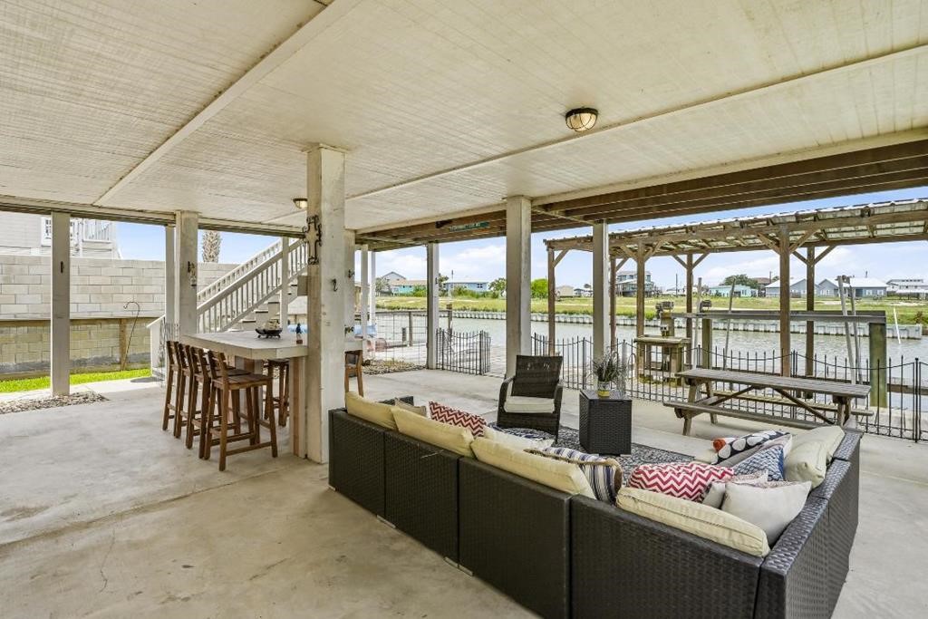 838 Rattlesnake Point Road Rockport, TX 78382 - Photo 30 of 40 a living room with furniture and a floor to ceiling window