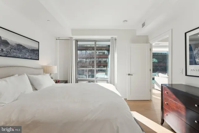 a bedroom with a bed and a large window