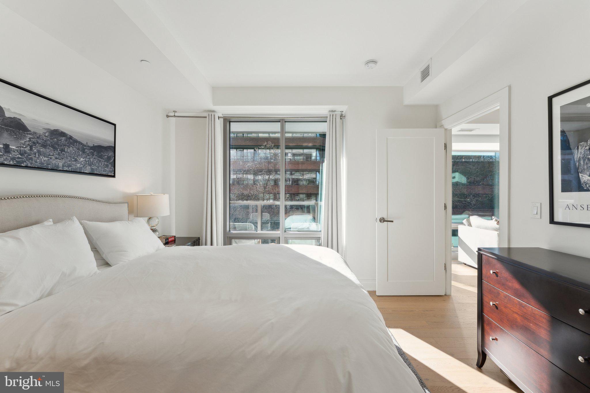 2501 M Street Northwest, Unit 207 Washington, DC 20037 - Photo 12 of 30 a bedroom with a bed and a large window