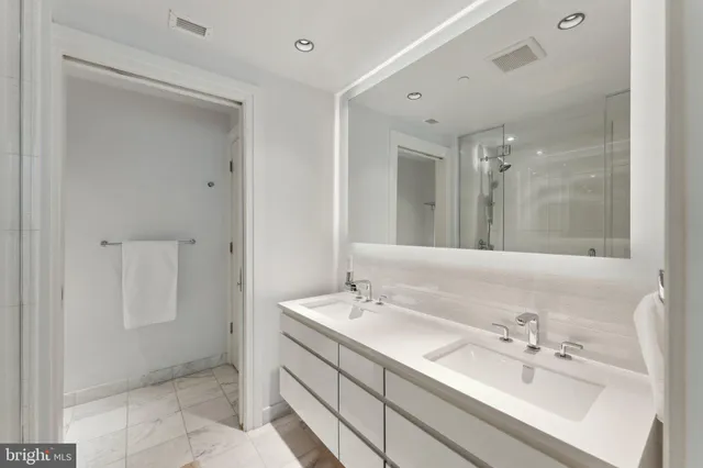 a bathroom with a sink tub and a mirror