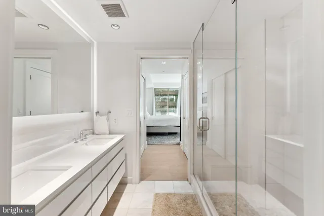 a en suite bathroom with a shower and a sink