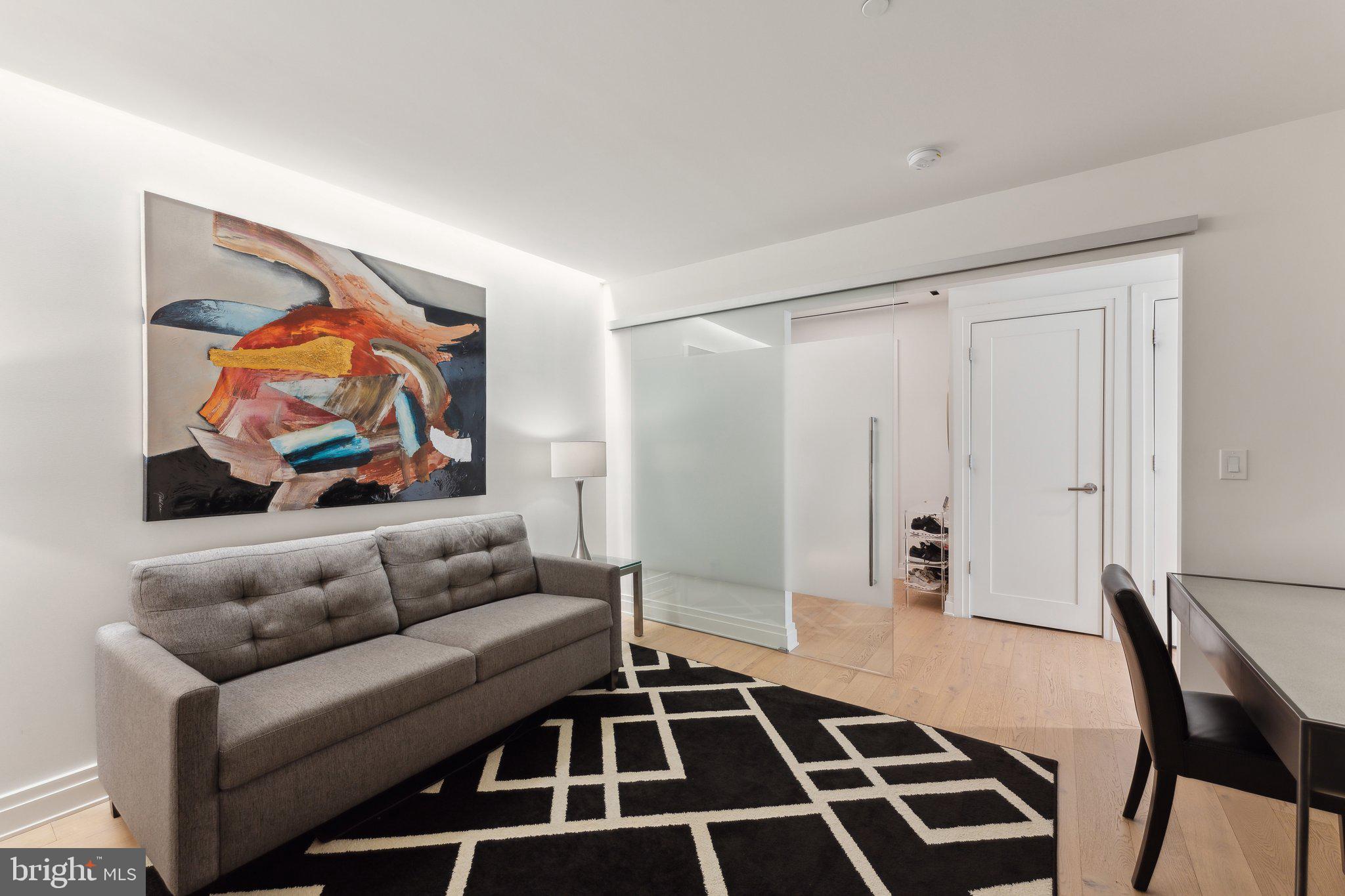 2501 M Street Northwest, Unit 207 Washington, DC 20037 - Photo 16 of 30 a living room with furniture and a rug
