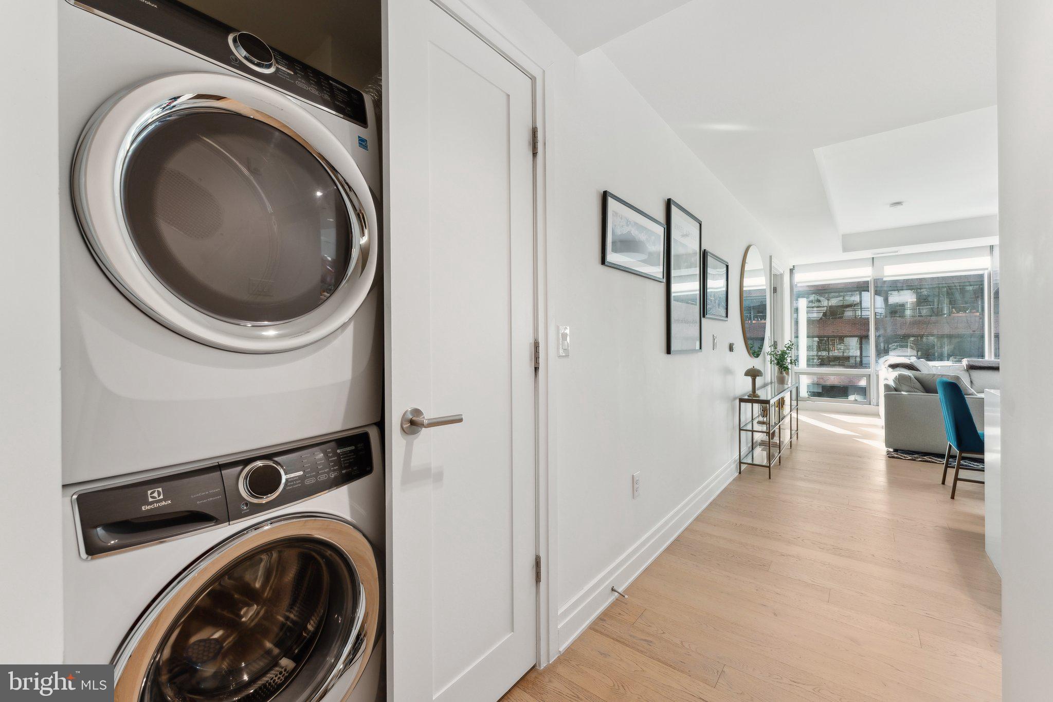 2501 M Street Northwest, Unit 207 Washington, DC 20037 - Photo 18 of 30 a view of a hallway with washer and dryer