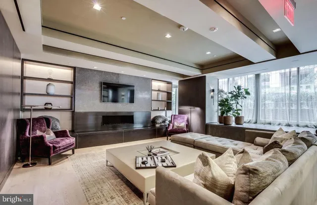 a living room with furniture window and a flat screen tv