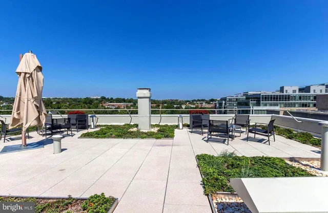 a view of a patio with a table and chairs