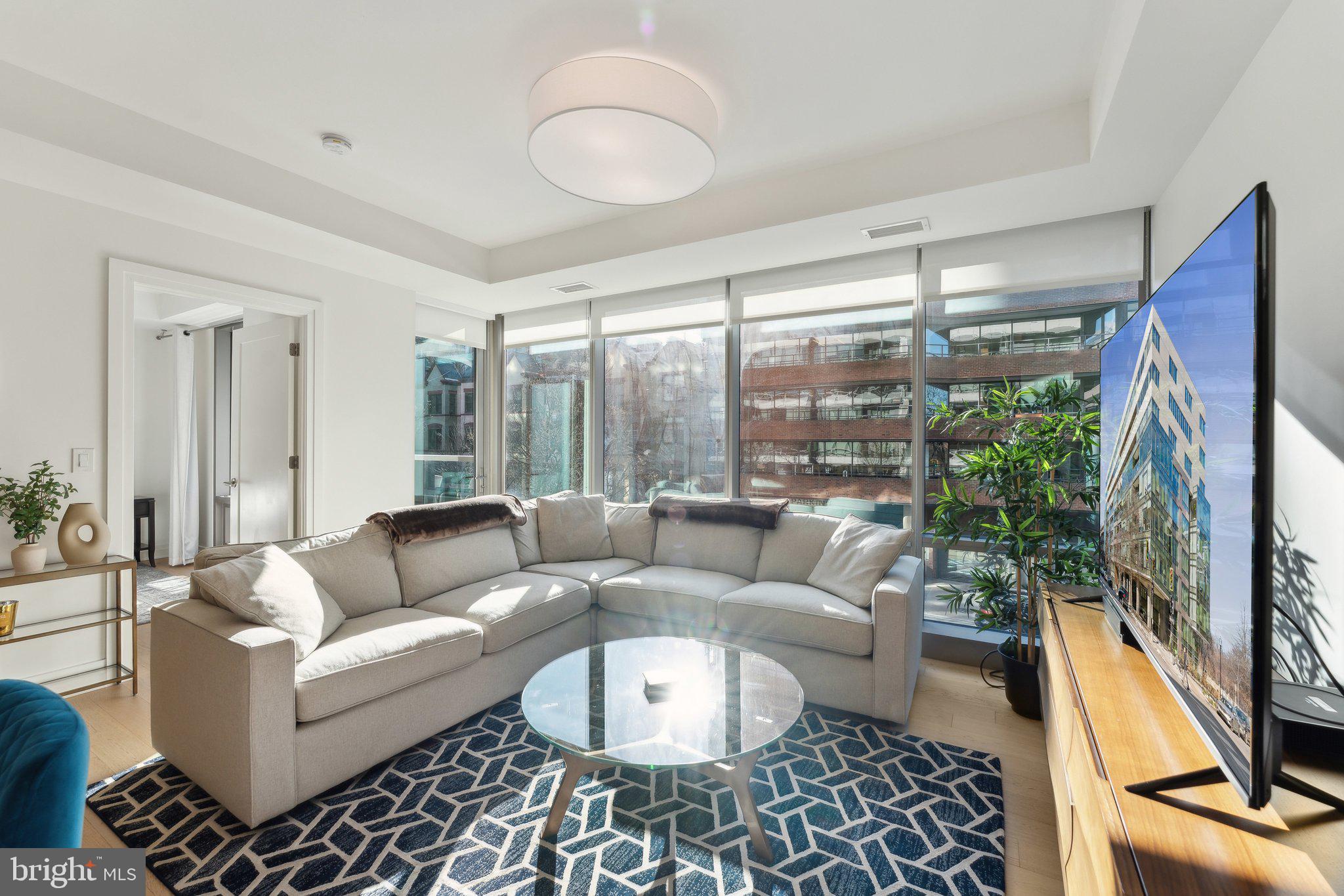 2501 M Street Northwest, Unit 207 Washington, DC 20037 - Photo 3 of 30 a living room with furniture and a large window
