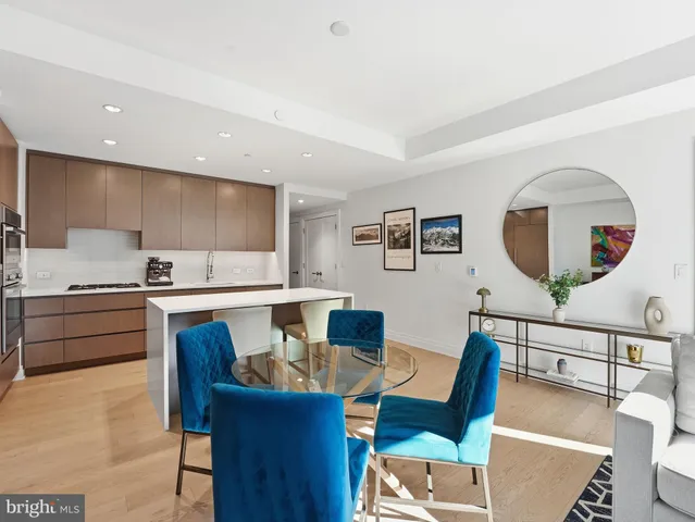 a living room with furniture a mirror and a table