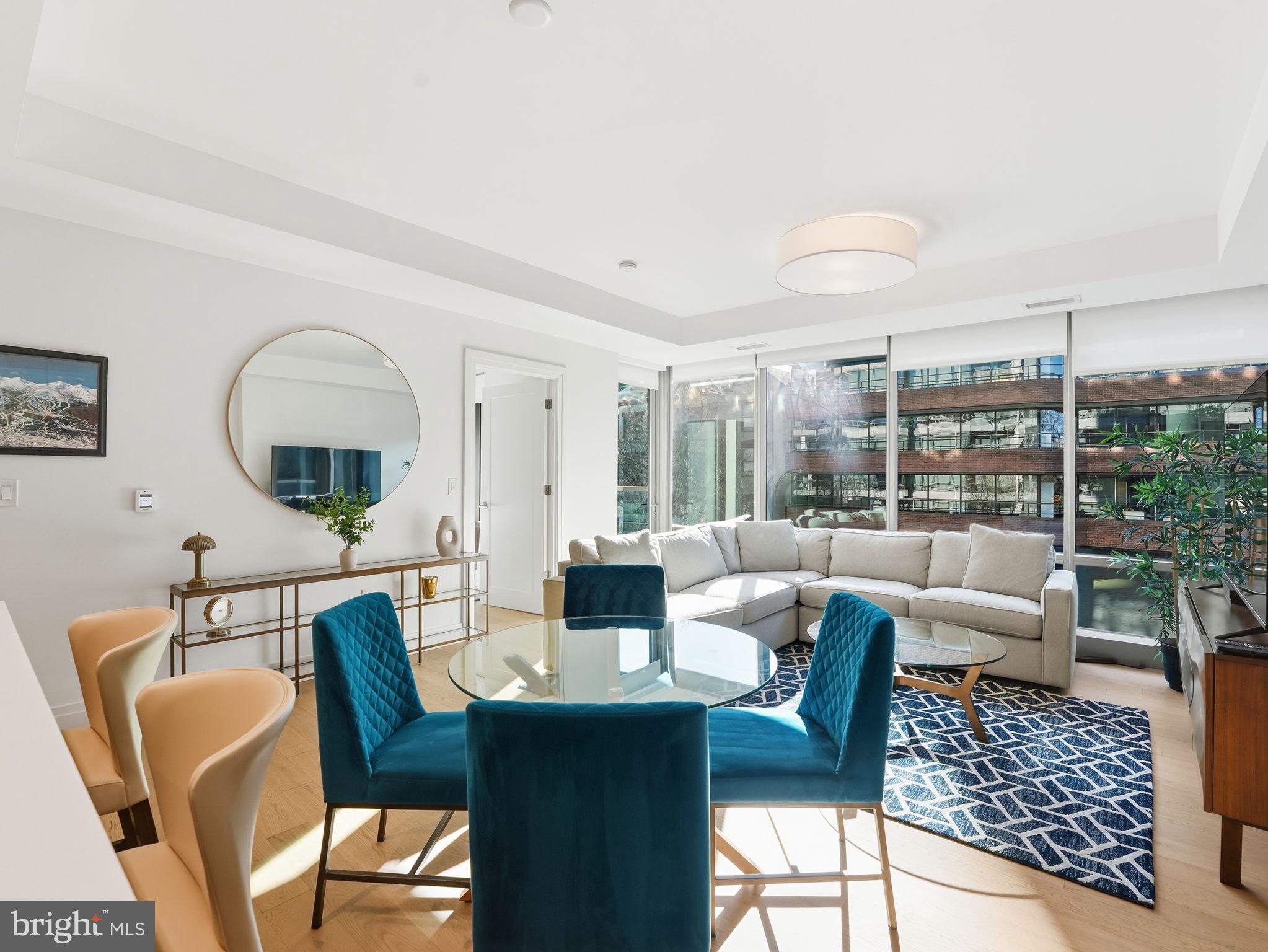 2501 M Street Northwest, Unit 207 Washington, DC 20037 - Photo 6 of 30 a living room with furniture and a large window