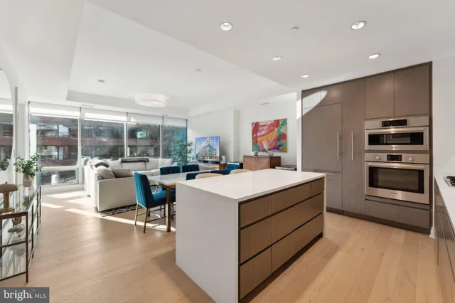 a kitchen that has a lot of cabinets in it and wooden flooring