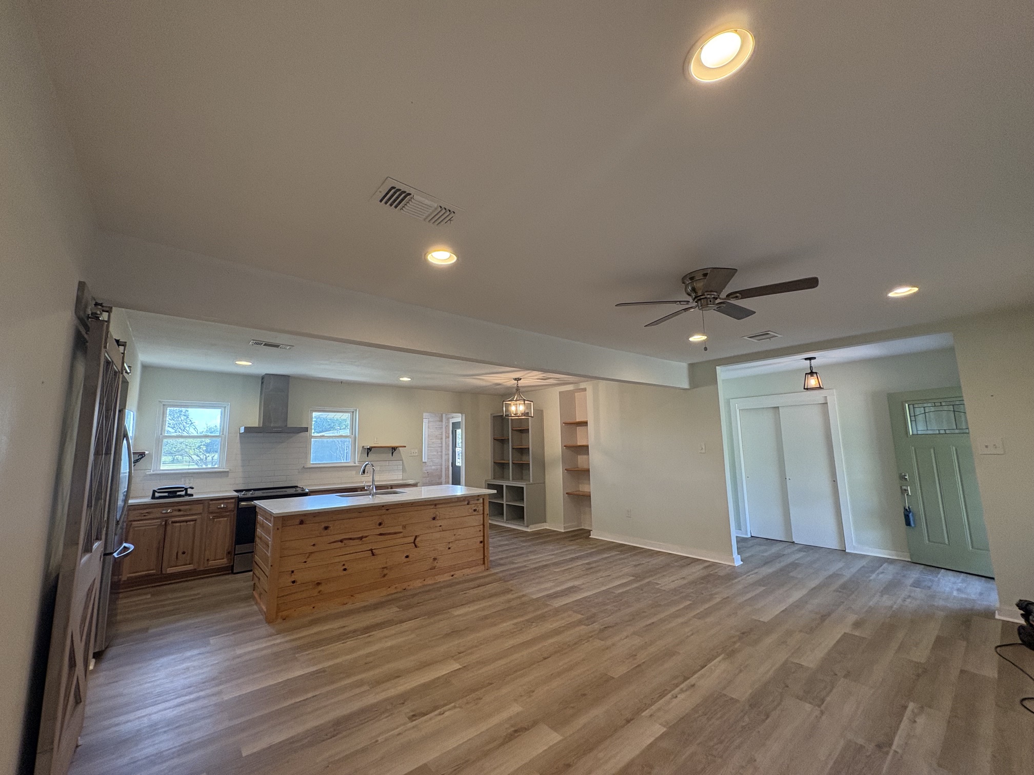 9032 Nuckols Crossing Road Austin, TX 78744 - Photo 5 of 14 An open-concept living space features an integrated kitchen, inviting gatherings and seamless flow.