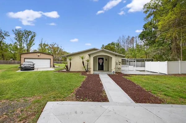 a front view of a house with a garden and yard