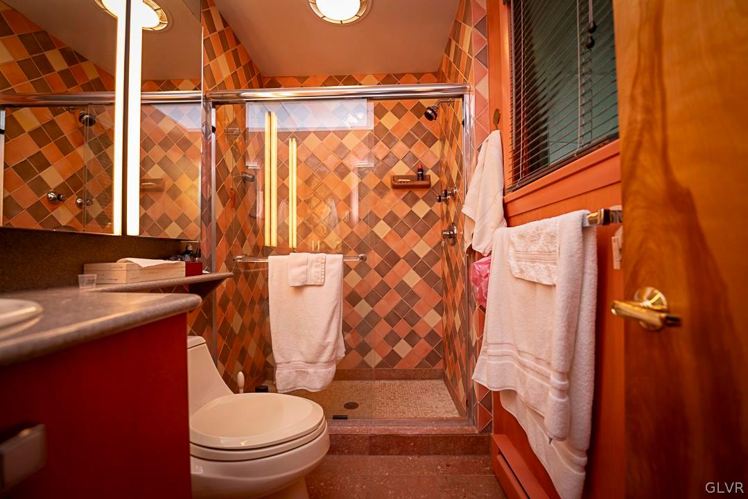 403 Georgetown Road Nazareth, PA 18064 - Photo 28 of 50 a white toilet sitting next to a shower curtain