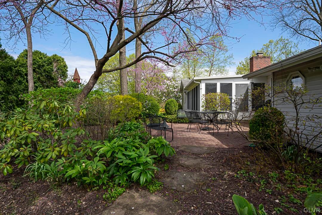 403 Georgetown Road Nazareth, PA 18064 - Photo 7 of 50 a backyard of a house with table and chairs under an umbrella