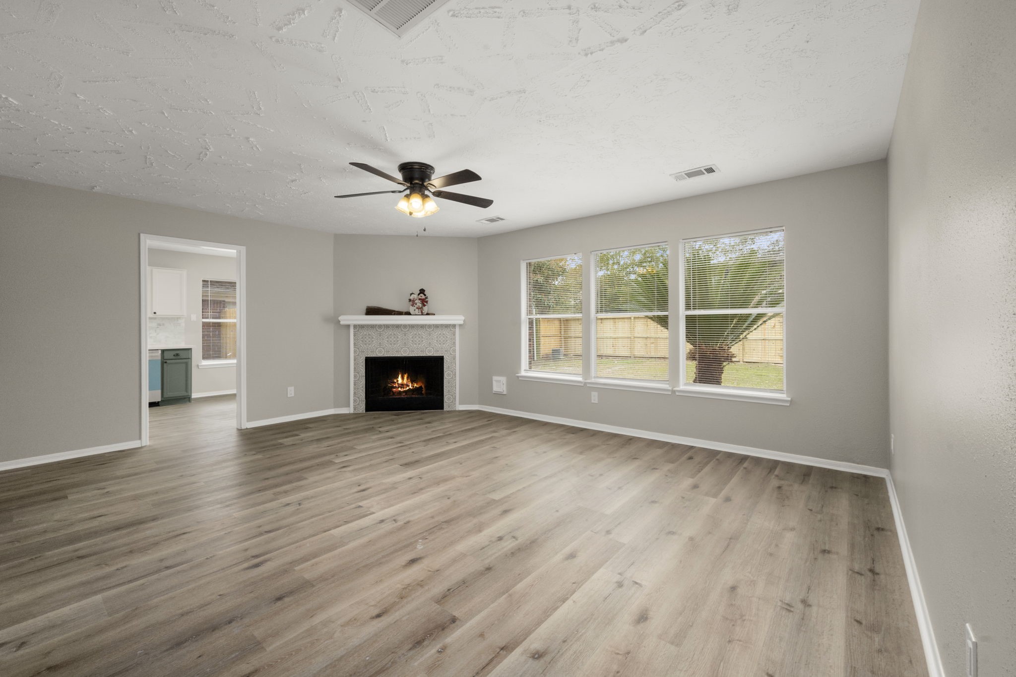 6615 Broken Stone Houston, TX 77084 - Photo 12 of 29 wooden floor fireplace and windows in an empty room