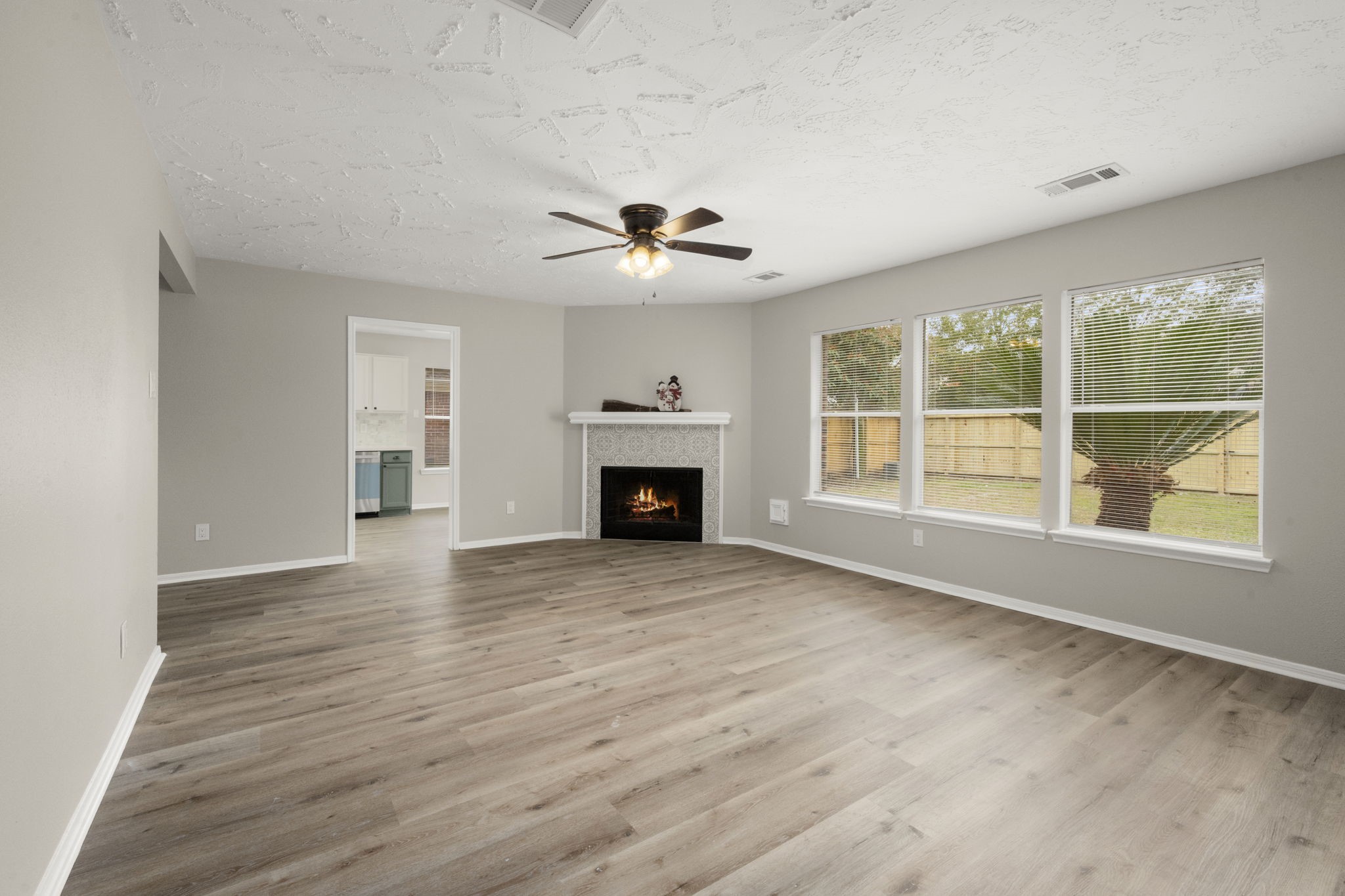 6615 Broken Stone Houston, TX 77084 - Photo 13 of 29 a view of an empty room with a fireplace and a window