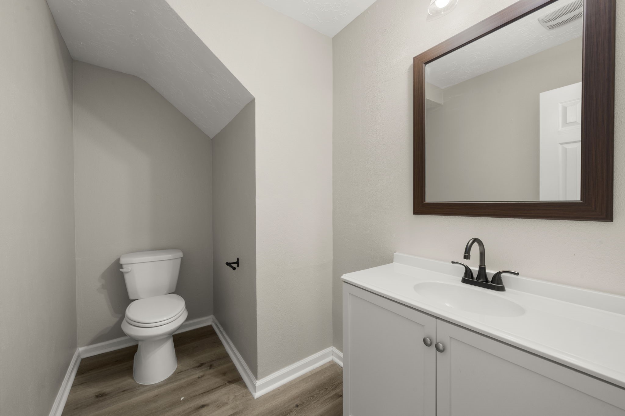 6615 Broken Stone Houston, TX 77084 - Photo 20 of 29 a bathroom with a toilet a sink and mirror