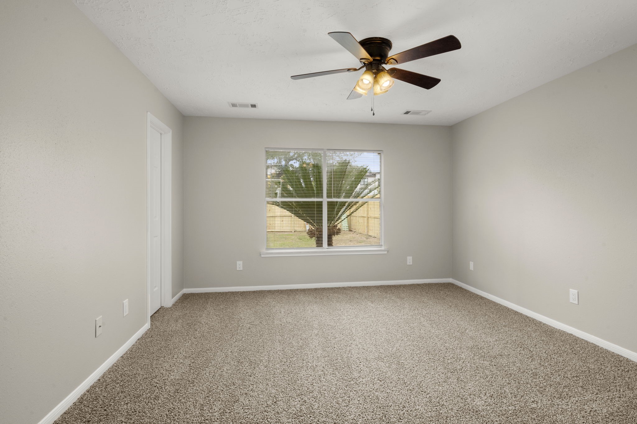 6615 Broken Stone Houston, TX 77084 - Photo 21 of 29 an empty room with window and ceiling fan