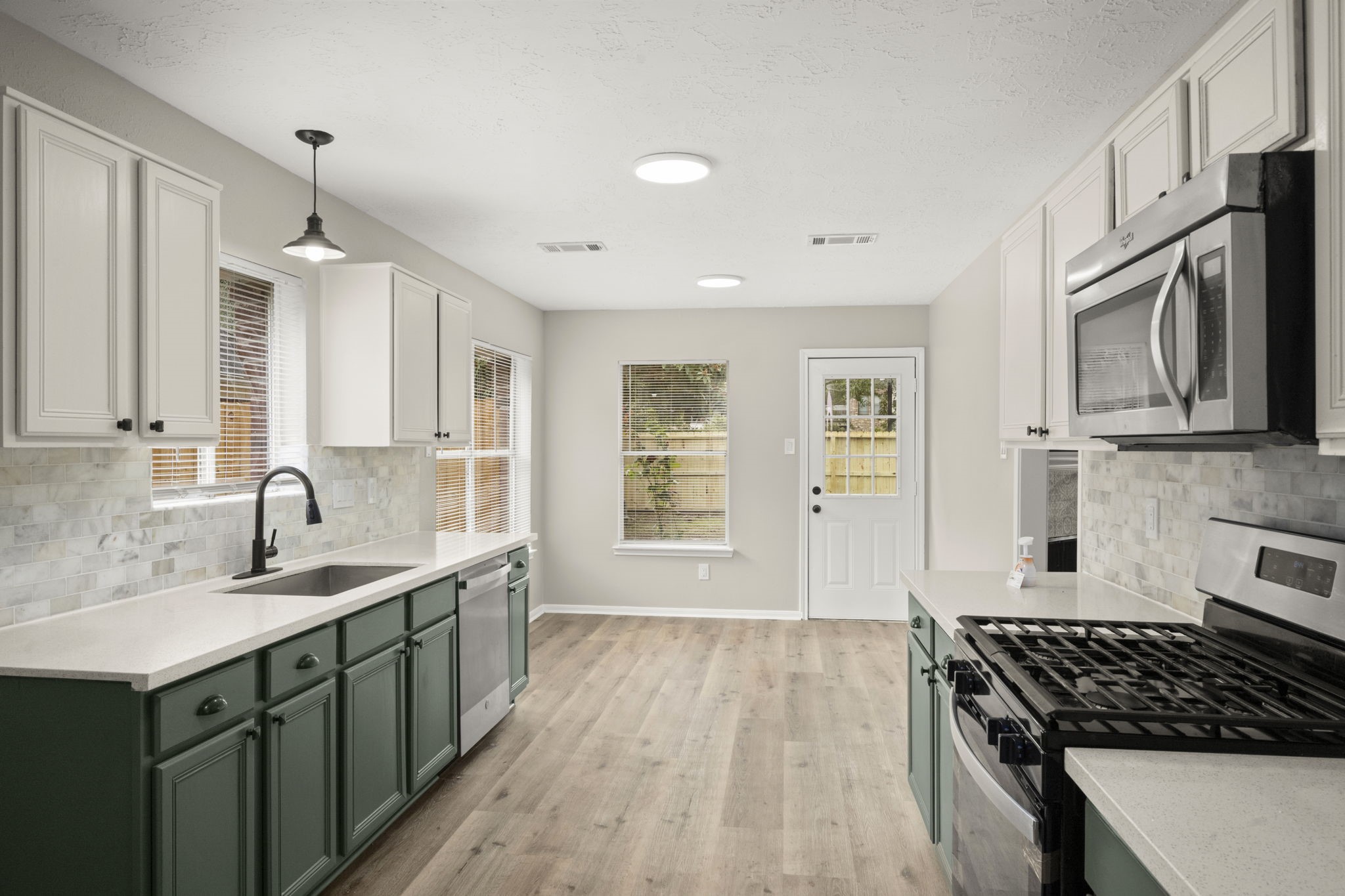 6615 Broken Stone Houston, TX 77084 - Photo 6 of 29 a kitchen with stainless steel appliances a sink stove and cabinets