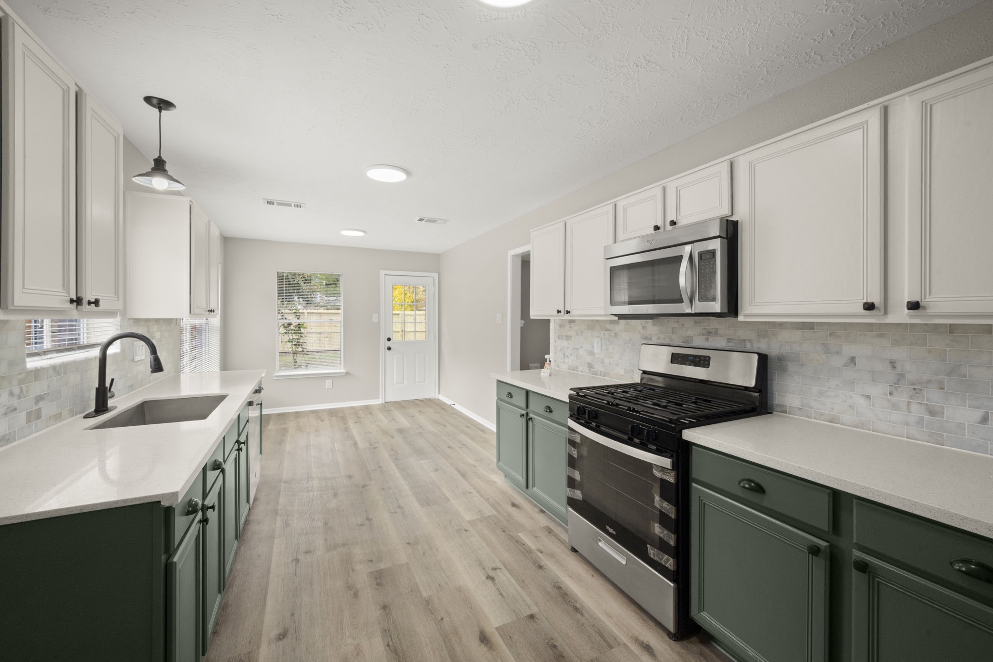 6615 Broken Stone Houston, TX 77084 - Photo 7 of 29 a kitchen with granite countertop a sink a counter space appliances and cabinets